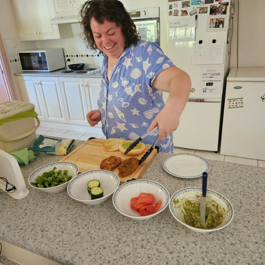 Shine Social SDA participant cooking in a kitchen